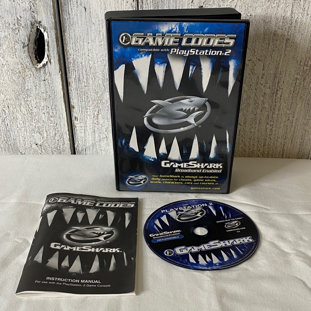 Game Codes for PlayStation 2 - Black and Blue game shark vintage ps2 retro game